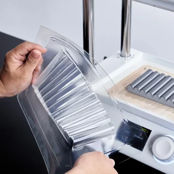 TPU sheet for vacuum forming Two hands are holding the newly molded TPU mold and demonstate the softness.