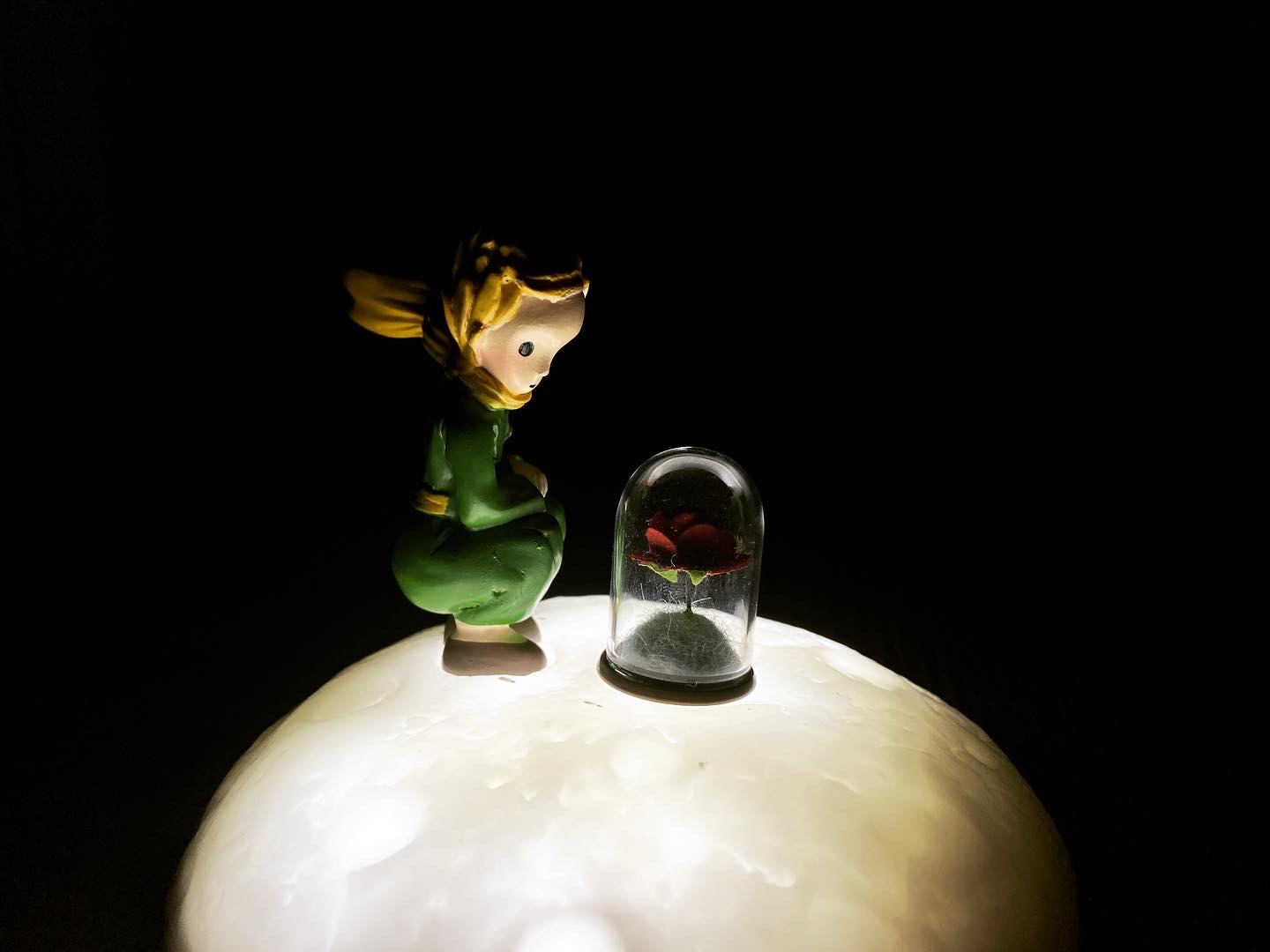 Resin moon-shaped LED lamp with a small prince gazing at his rose on top, made from an LDPE resin mold.