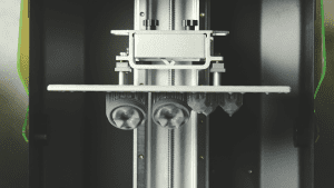 A 3D printer in action, printing molds with detailed layers and the structure in progress