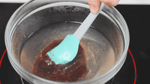 Stirring the yokan mixture in the pot with a spatula, preparing for the next step of the process.
