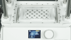 Operating FORMART vacuum forming machine to create parts tray