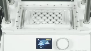 Operating FORMART vacuum forming machine to create parts tray