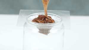 Pouring liquid into the volcano-shaped yokan mold, preparing to complete the final step of the dessert.