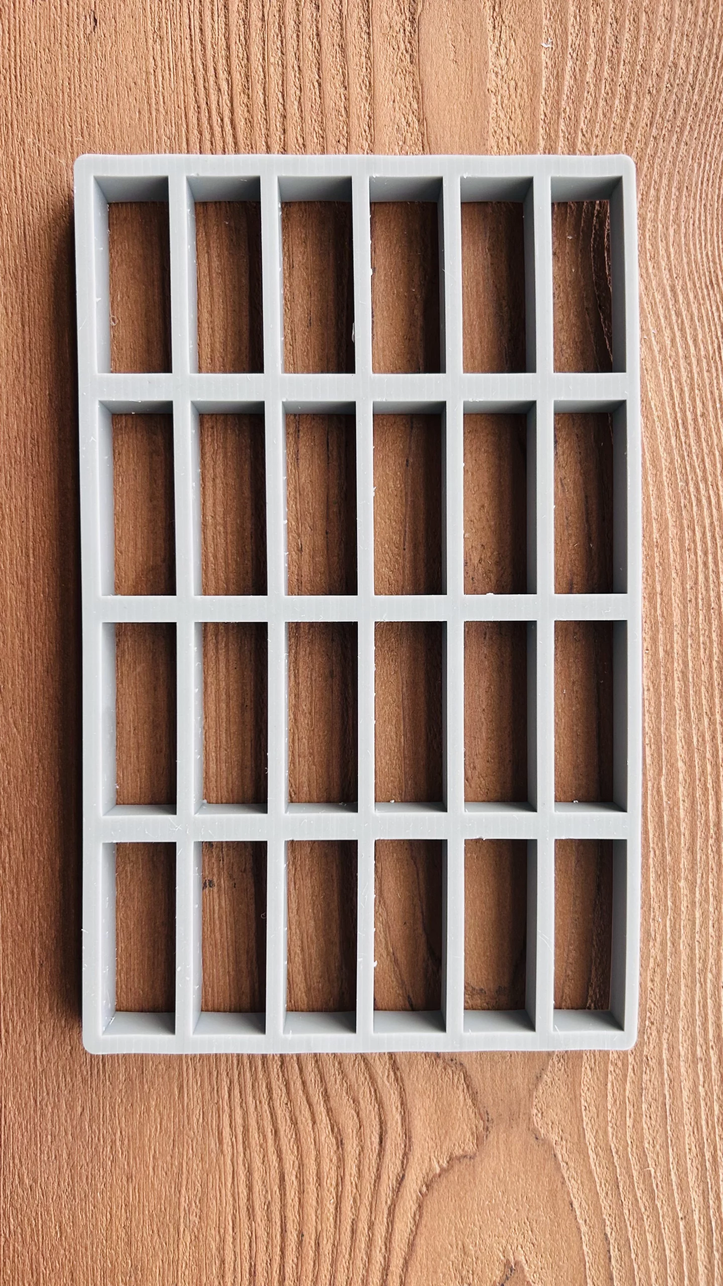 Cutting fixture grid for trimming a custom parts tray